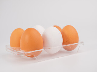 Chicken eggs on a white background. White and brown egg on a white background.