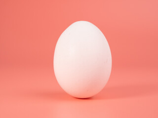 Chicken eggs on a pink background. White egg on a pink background.
