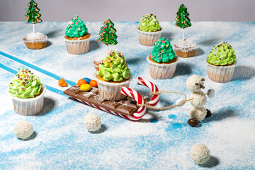 Christmas still life of sweets: cupcakes, sweets, caramel, candies. Snowman Olaf of coconut candy...