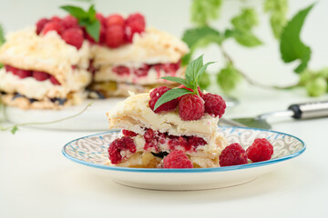 Round meringue pie with fresh raspberries on a white background, Pavlova dessert