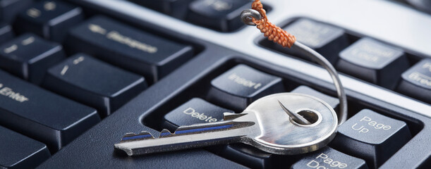phishing, hacking personal data and money , key and hook on computer keyboard.