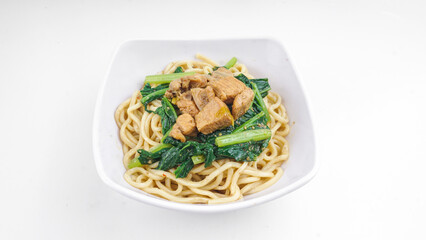 Indonesian food, Mie Ayam or Bami ayam, noodles with chicken and served on white bowl