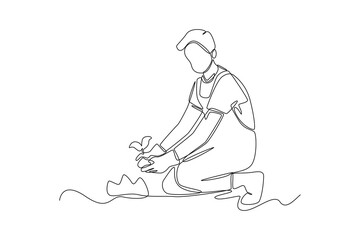 Continuous one line drawing Boy farmer planting plant shoots in the ground. Agriculture concept. Single line draw design vector graphic illustration.