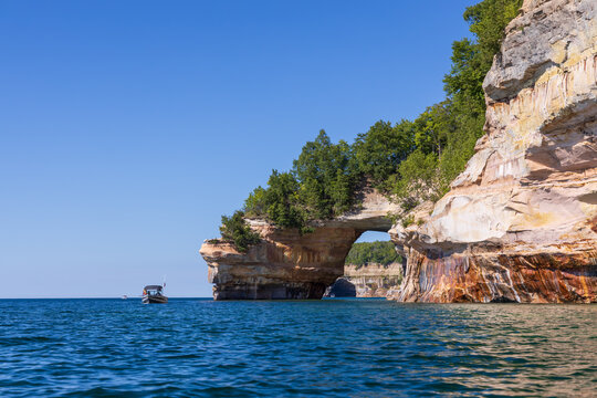 Boat next to Lover's Leap rock arch in Lake Superior at Pictured Rocks National Lakeshore, Upper Peninsula, Michigan, USA