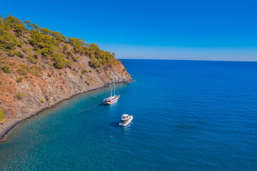 Fototapeta na wymiar Tropical beach white yacht on blue sea Antalya, Turkey Aerial top view. Concept beautiful travel summer landscape