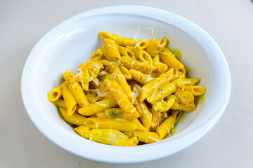 Macaroni Salad with red bell pepper, onion, celery, gherkins and mayonnaise dressing.Traditional Italian pasta with vegetables and creamy cottage cheese in a bowl. Fettuccini, alfredo makarna. 