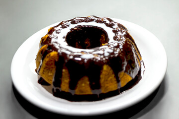 Carrot cake, homemade, with chocolate frosting.