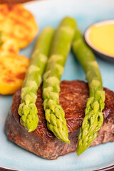 asparagus with potatoes and a steak