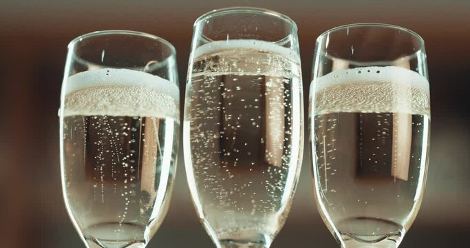 Glass, champagne and alcohol, bubbles and toast for new year, party and celebration against blurred background. Drink zoom with cocktail and cheers, celebrate holiday with sparkling wine and drinking
