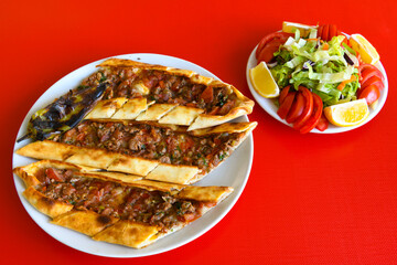 Kiymali pide. Turkish pide with minced meat. Turkish pizza mince pita Pide on white background. Etli ekmek. Kusbasili pide.