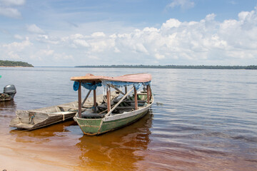 Fototapeta premium Old wooden passenger boat that are common docked on the shore of the Rio Negro in Airao , Brazil