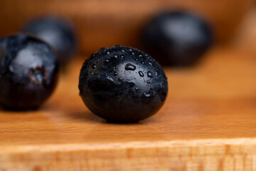 Wet black and blue grapes on the table