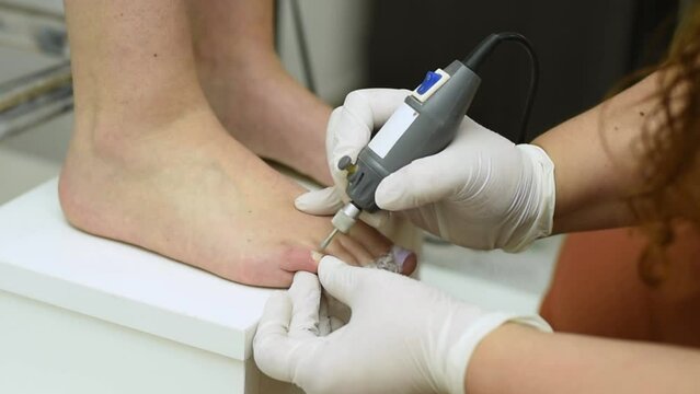 Complete treatment of pedicure and podiatry for health, aesthetics and beauty of the feet and nails in an aesthetic center with a scalpel, file and creams