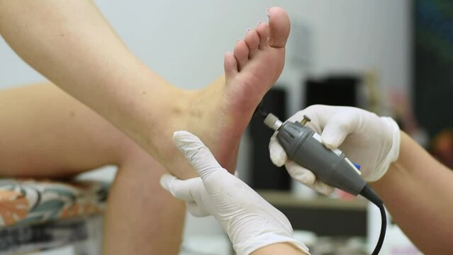Complete treatment of pedicure and podiatry for health, aesthetics and beauty of the feet and nails in an aesthetic center with a scalpel, file and creams