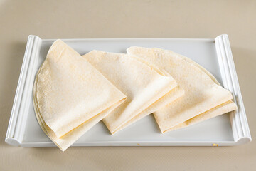 Freshly baked appetizing Turkish tortillas - Gozleme with spinach, cheese  on a wooden board. Space for text. Shallow depth of  field. Handmade Turkish traditional pastries.