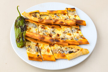 Pide, karisik pide, mixed pita. Turkish pide with sucuk sausage, meat and cheese. Turkish pizza. mixed pita. Pide on white background. 