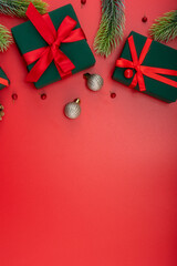 Christmas composition. Festive decor on red background. Copy space, flat lay, top view.
