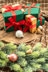 Christmas present on wooden cutting board with Christmas decorations.