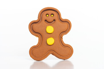 Gingerbread man figure with yellow eyes on a white background