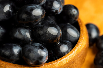 Wet black and blue grapes on the table