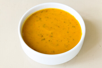 Lentil ( mercimek ) soup with melted butter and red pepper sauce. Mercimek corbasi