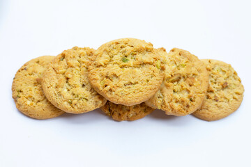 Pistachio and almond cookies on white background.