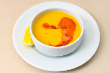 Lentil ( mercimek ) soup with melted butter and red pepper sauce. Mercimek corbasi