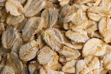 Oat flakes poured into a wooden bowl