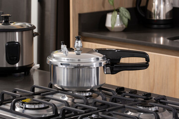 Practical silver pressure cooker in modern kitchen