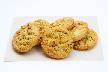 Pistachio and almond cookies on white background.