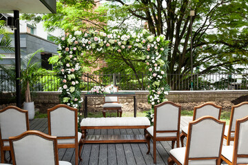 Wedding Ceremony Arch, An Altar Decorated With Flowers On The Lawn