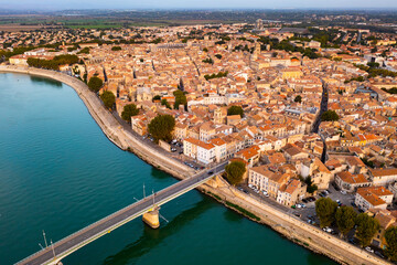 Aerial townscape of Arles with view of Arles Amphitheatre and Rhone River.