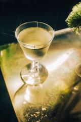 chilled white wine cocktail on brass gold table 