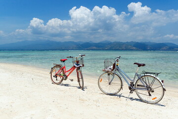 Fototapeta na wymiar Two bikes on the beach. Gili vibe