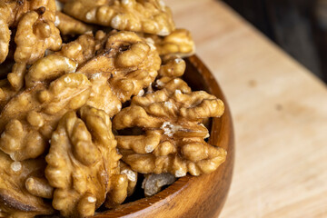 Peeled walnuts on a wooden surface
