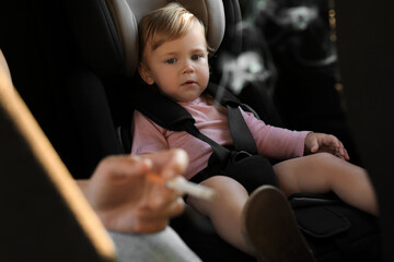 Mother with cigarette and child in car, closeup. Don't smoke near kids - obrazy, fototapety, plakaty