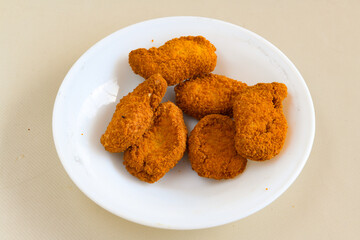 Fried Chicken breast hot crispy strips crunchy chicken tenders  isolated on white background.Nuggets isolated on white background on a plate