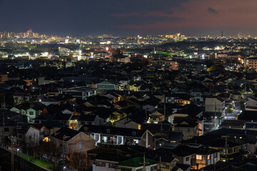 Aerial view of sprawling residential neighborhood near city at night - 551946159