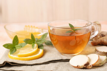 Tea with mint, honey, lemon and ginger on table
