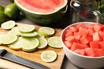 Fresh ingredients for making watermelon drink with lime on wooden table, closeup