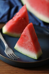 Sliced fresh juicy watermelon served on wooden table, closeup