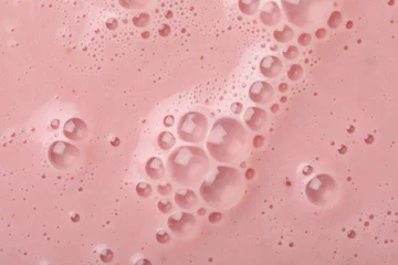 Zelfklevend Fotobehang Tasty pink smoothie with bubbles as background, closeup © New Africa