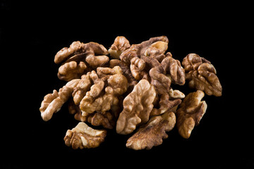 Walnut kernel, Nuts isolated on black background.