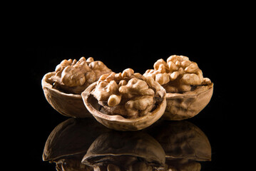 Walnut kernel, Nuts isolated on black background.