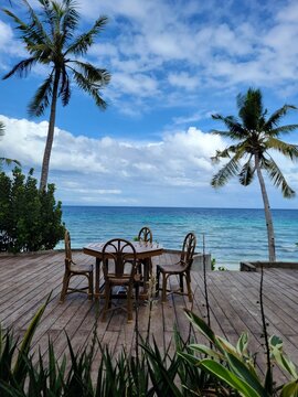 Dining table on wooden deck overlooking ocean - Siquijor, Philippines