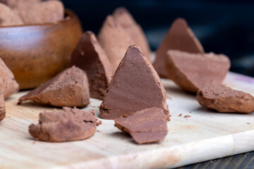 Cut into pieces truffle candy on a board