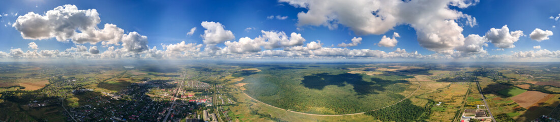 Aerial view from high altitude of earth covered with white puffy cumulus clouds on sunny day