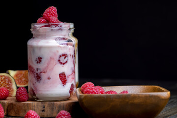 Milk yogurt with raspberries, close up
