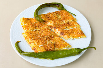Turkish style meat stuffed filo dough borek served kol boregi. Cheese and minced pie are sliced on a marble background. Turkish name: Kol Boregi, kiymali, peynirli su boregi.