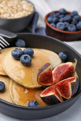Tasty oatmeal pancakes on white table, closeup